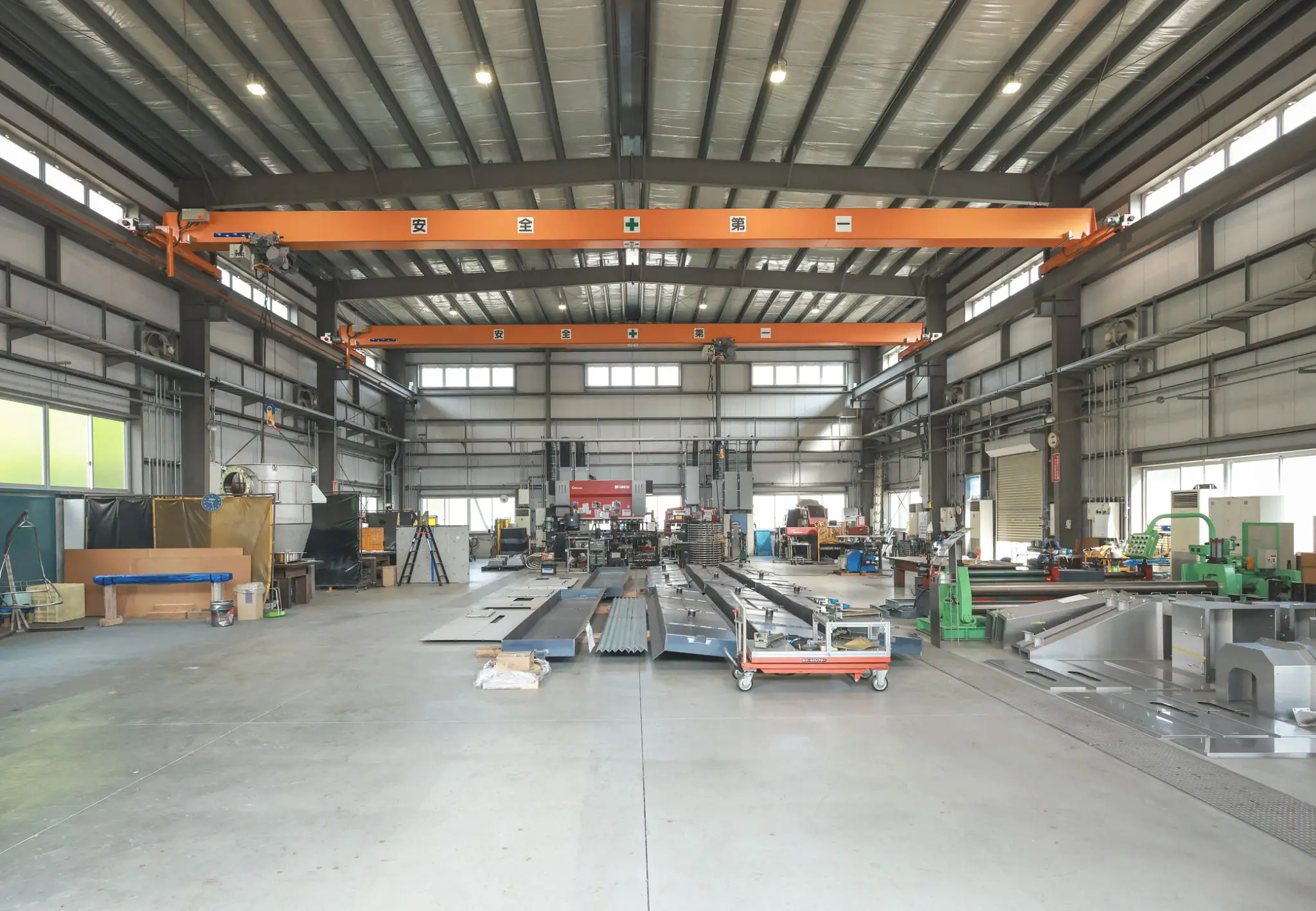 Spacious industrial workshop with heavy machinery and equipment.