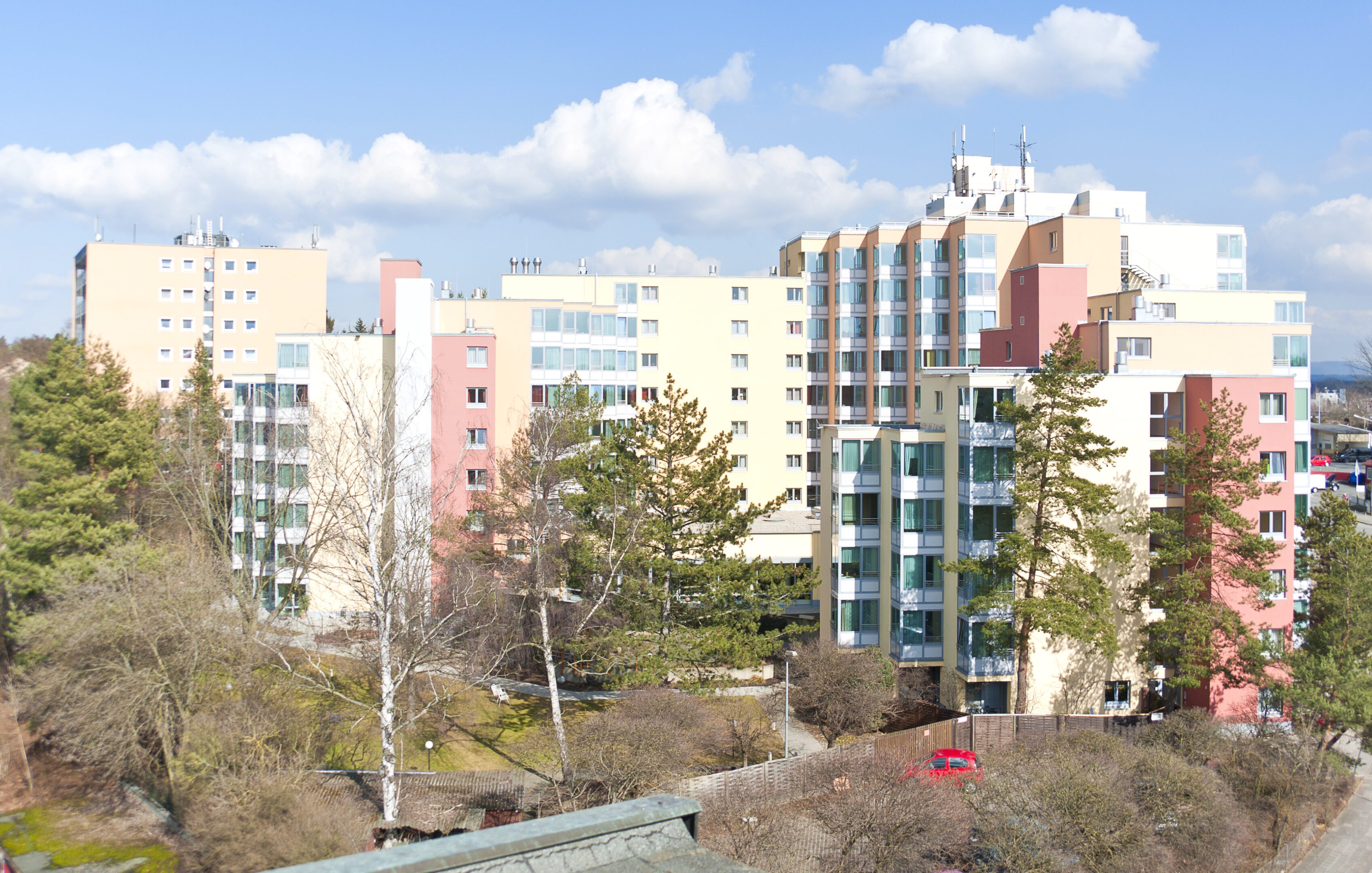 Residential buildings with colorful facades under a blue sky.
