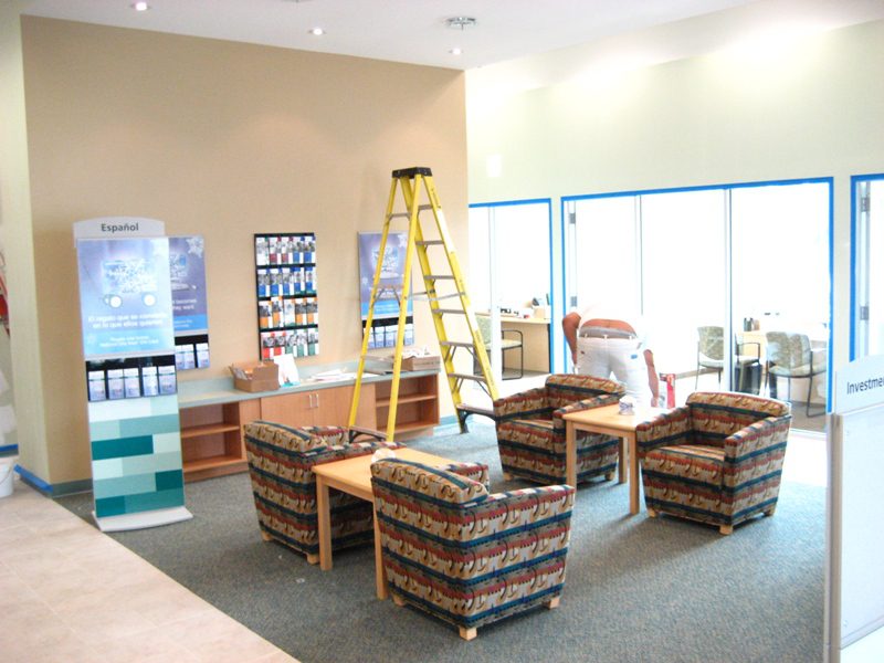 Modern waiting area with patterned chairs and a ladder.