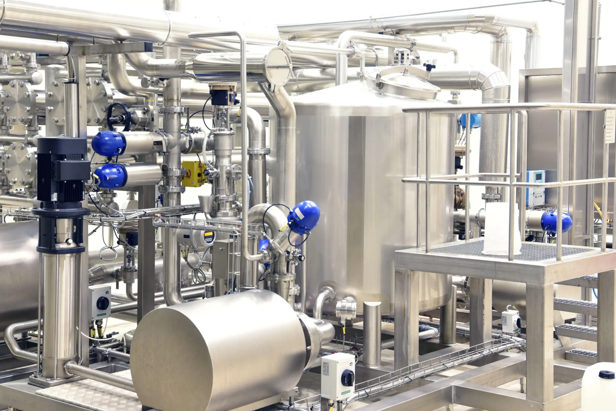 Stainless steel industrial machinery in a clean processing plant.