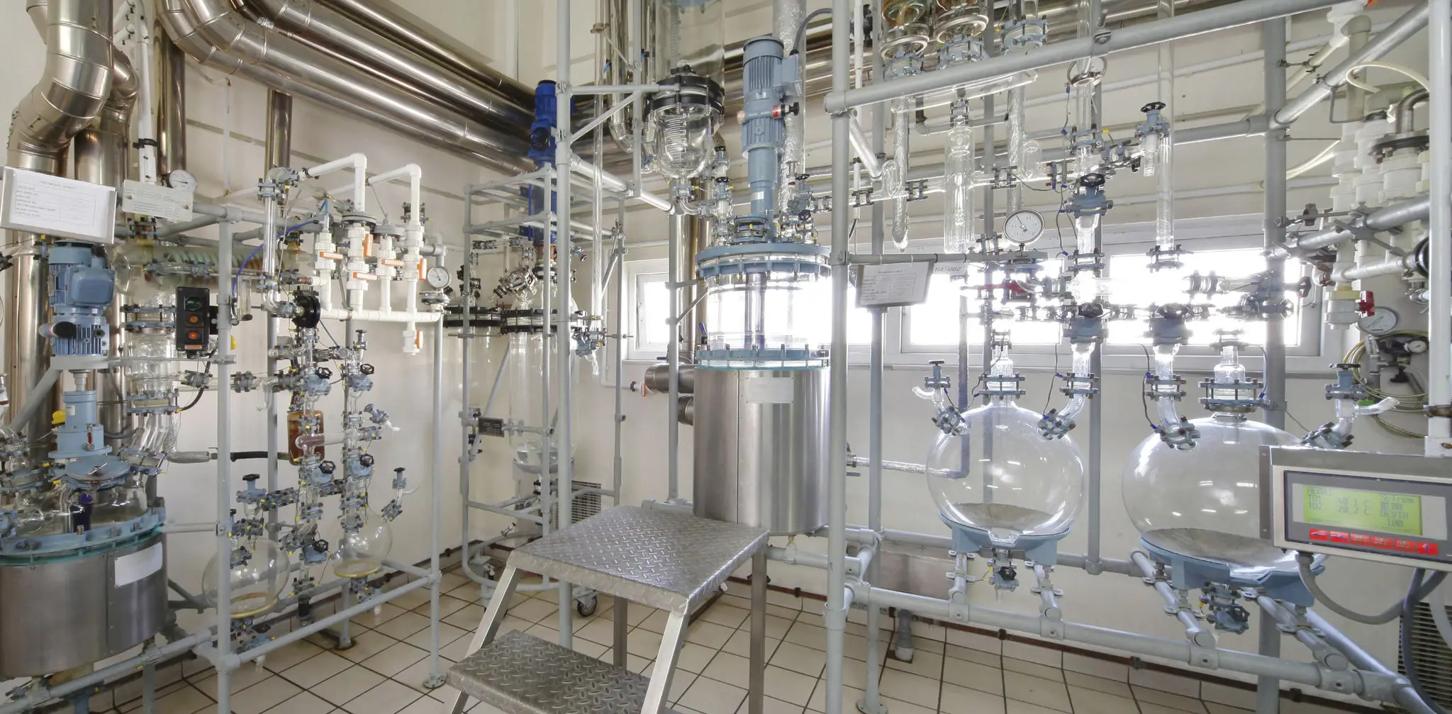 Industrial chemical processing equipment in a lab.