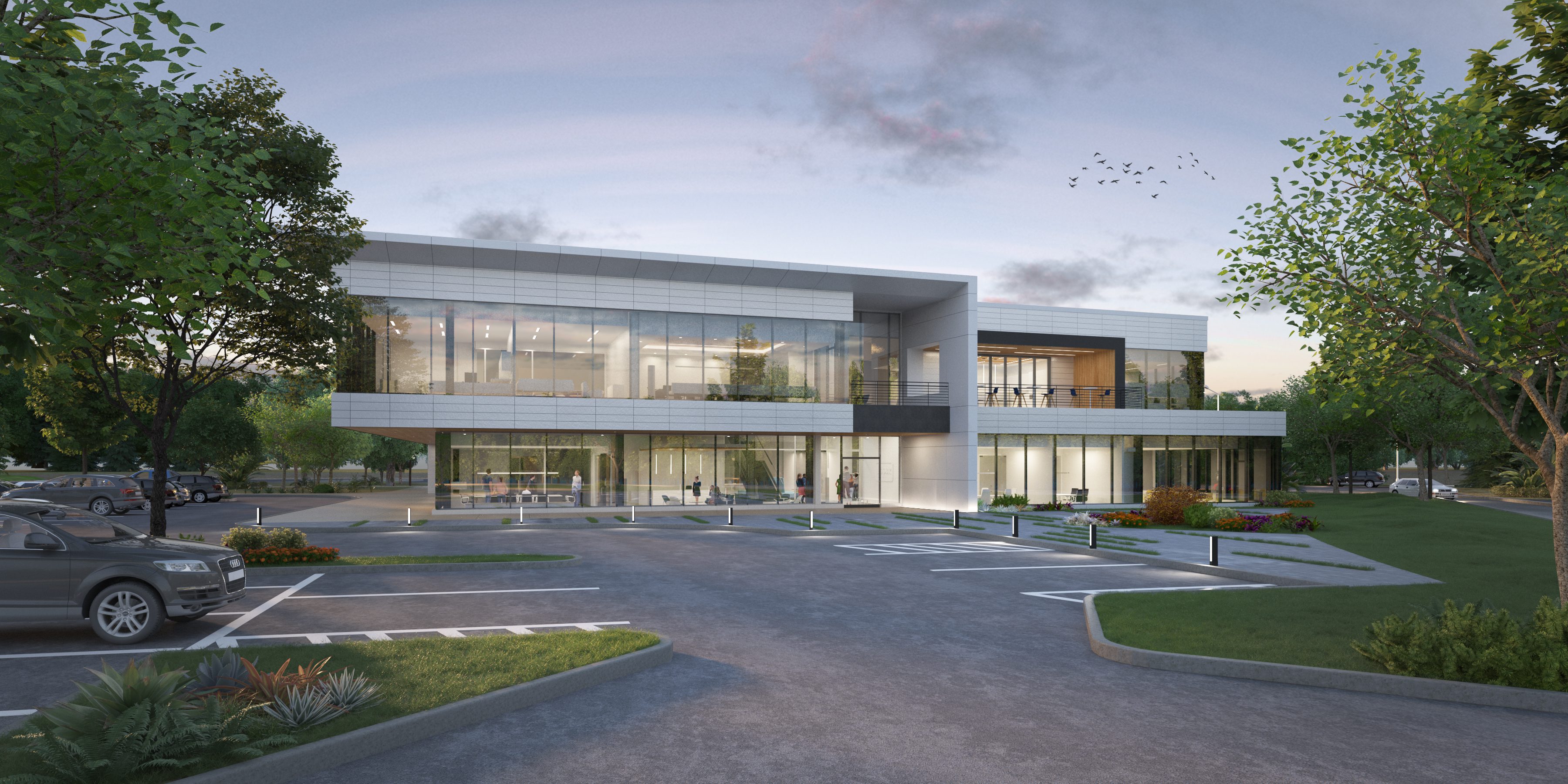 Modern two-story commercial building with glass facade and parking area.