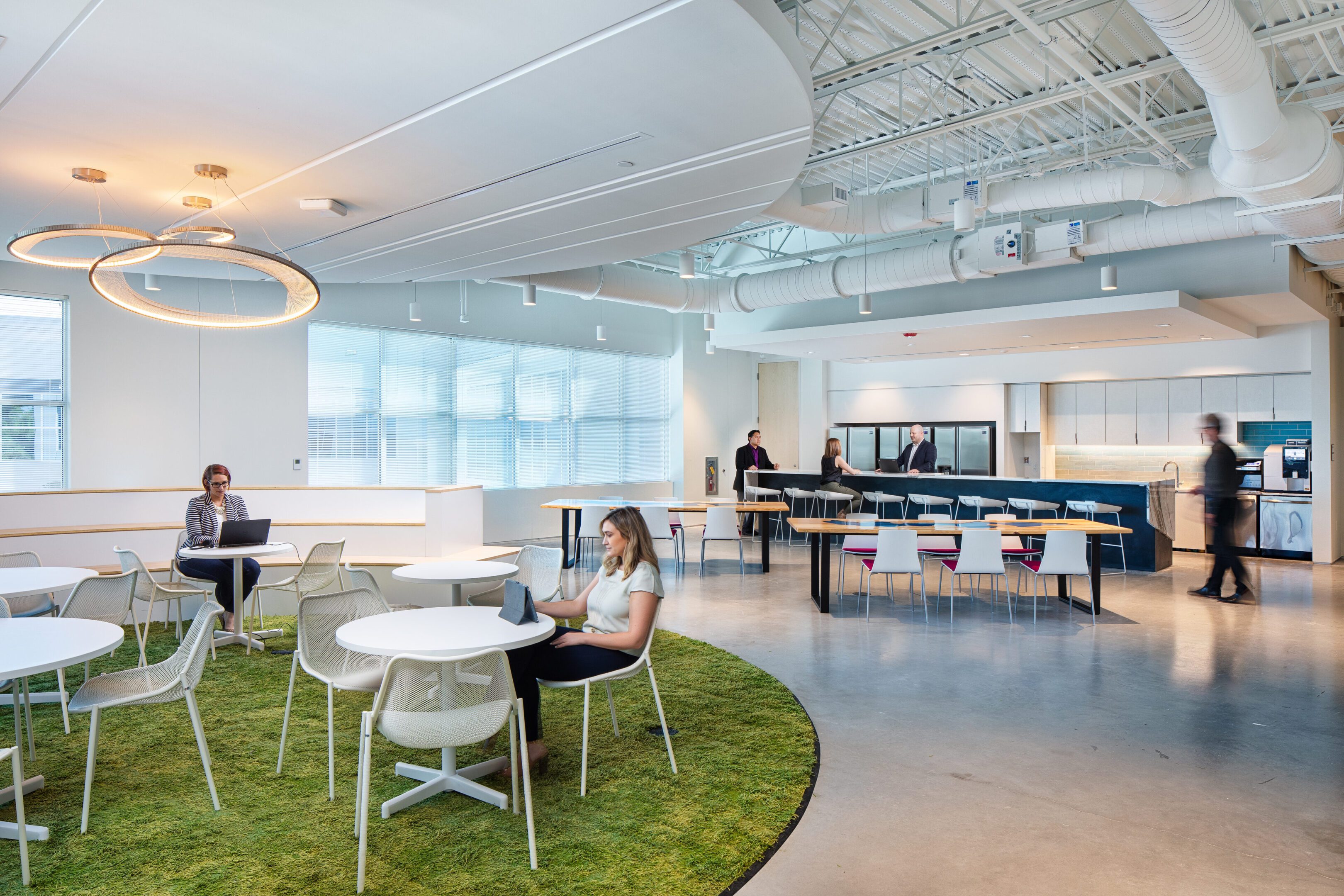 Modern office lounge with casual seating and recreational games.